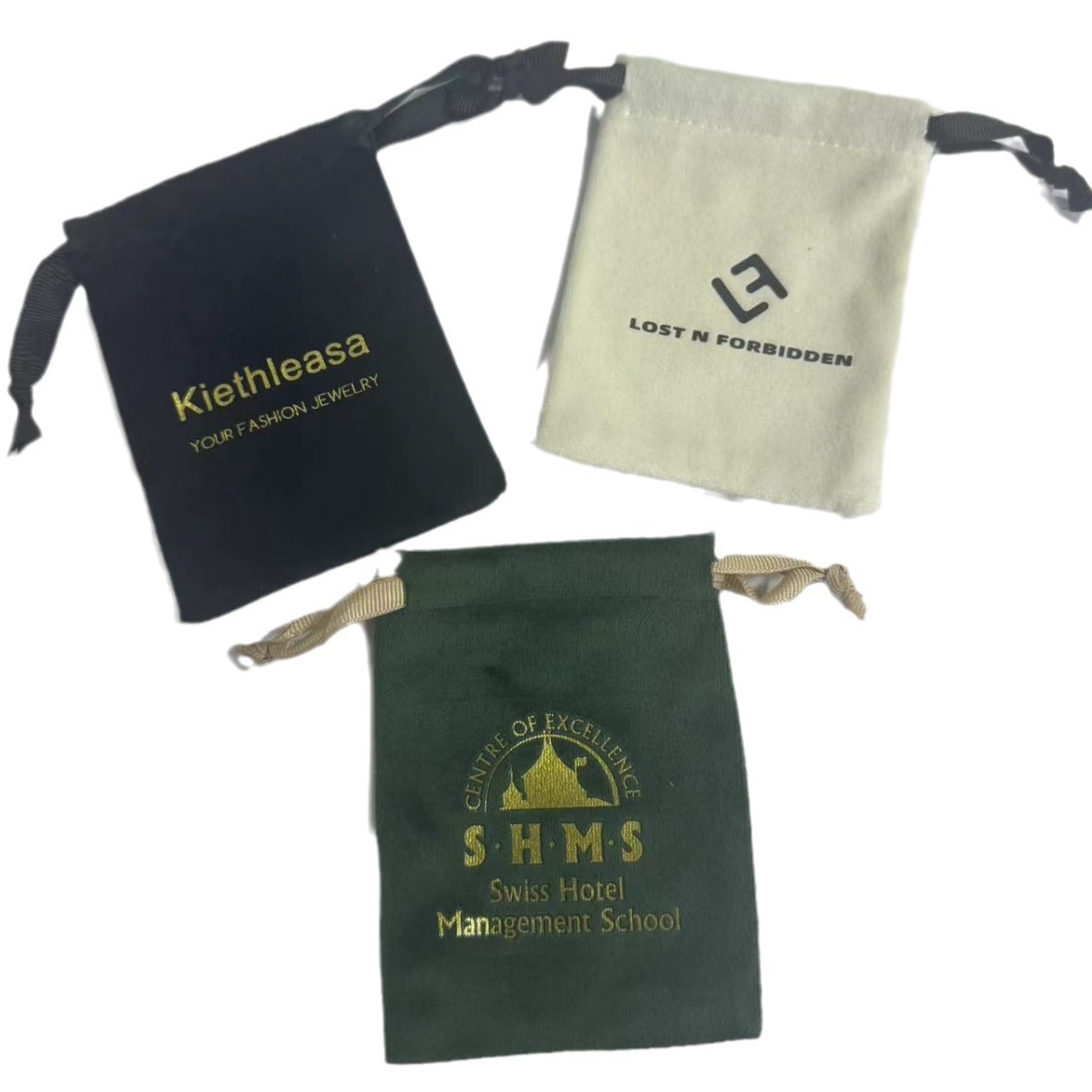 Custom branded velvet pouches in Black, Cream, and Emerald